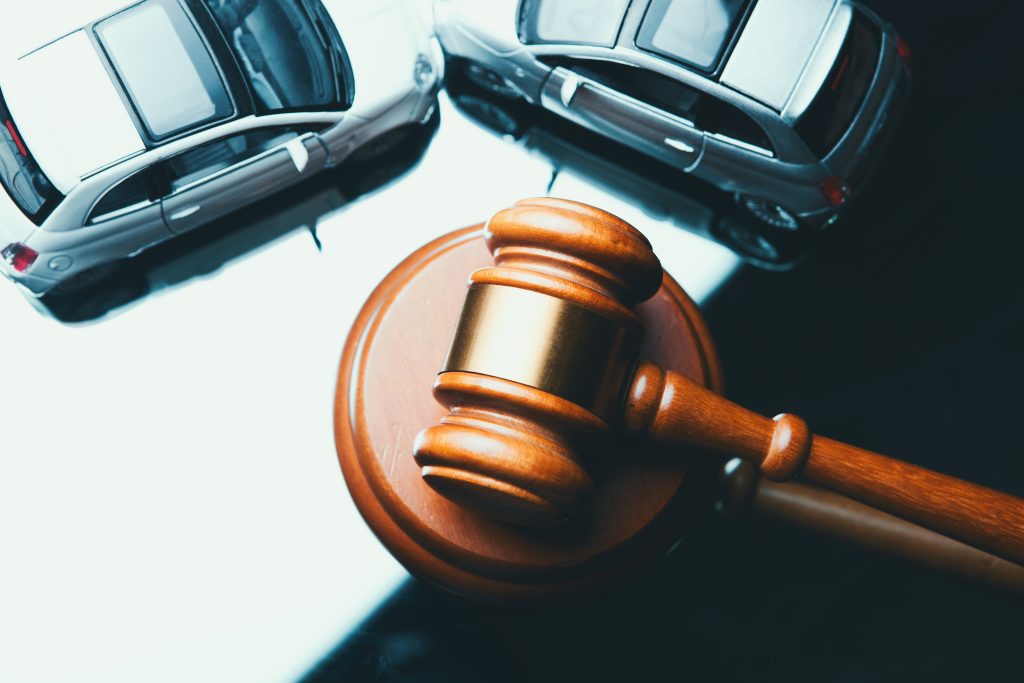 Model of car and gavel. Accident lawsuit or insurance, court case.