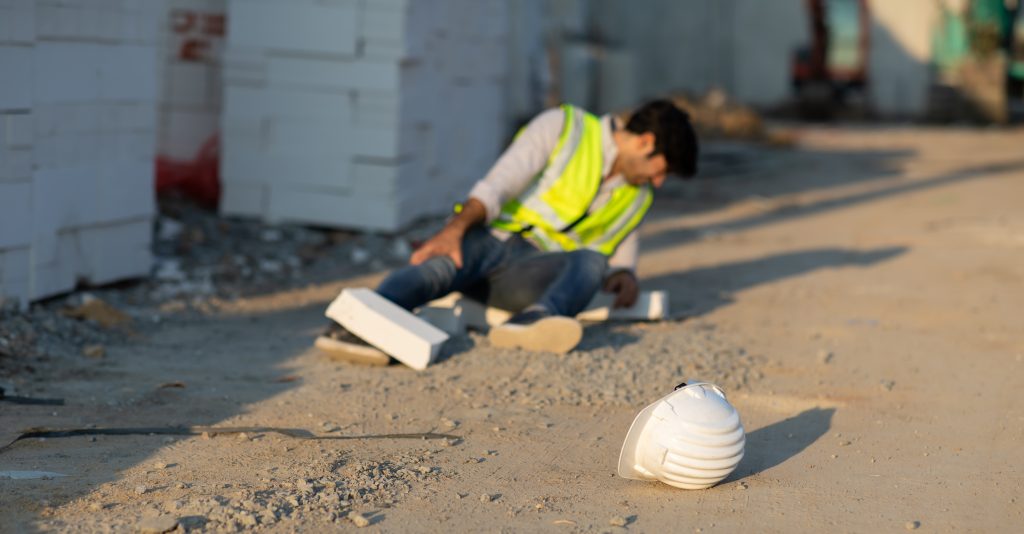Construction worker has an accident lying on the floor while working in construction site. Accident at work