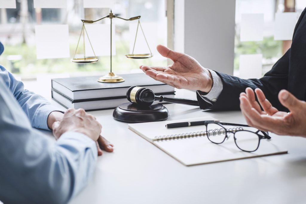 Consultation and conference of Male lawyers and professional businesswoman working and discussion having at law firm in office. Concepts of law, Judge gavel with scales of justice