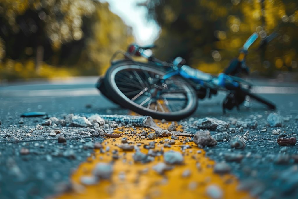 Damaged bicycle on the road after a car accident