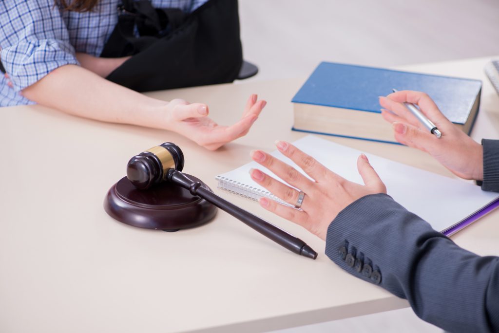 Injured employee visiting lawyer for advice on insurance