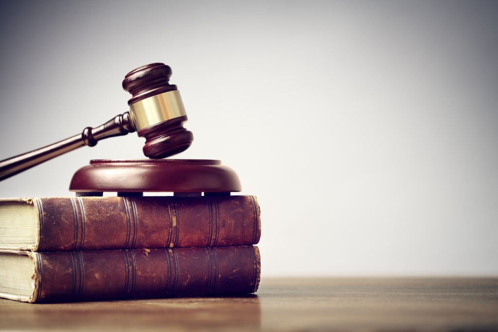 Judge gavel and law books in court background with copy space