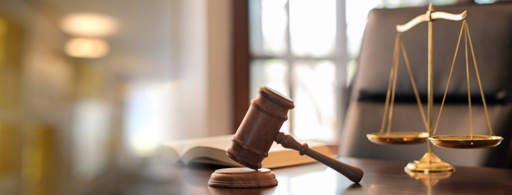 judge gavel, law books and scales of justice on desk in lawyer office.
legal justice concept.