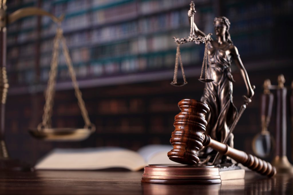 Law theme. Themis statue and judge gavel in the law faculty library.