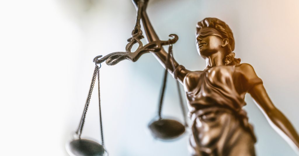 Statue of lady justice on bright background - Side view with copy space.
