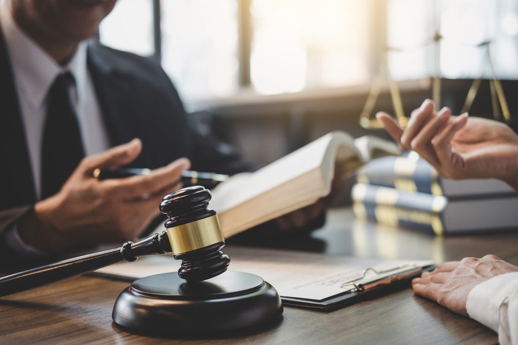 Businesswoman and Male lawyer or judge consult having team meeting with client, Law and Legal services concept