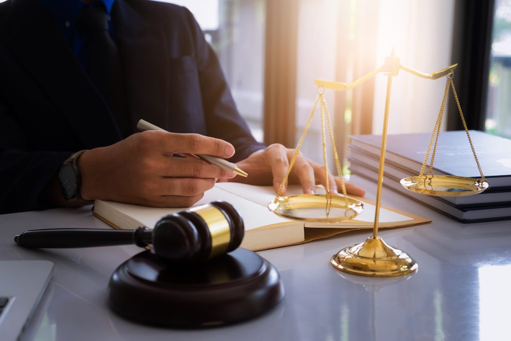 Close up lawyer businessman working or reading lawbook in office workplace for consultant lawyer concept.