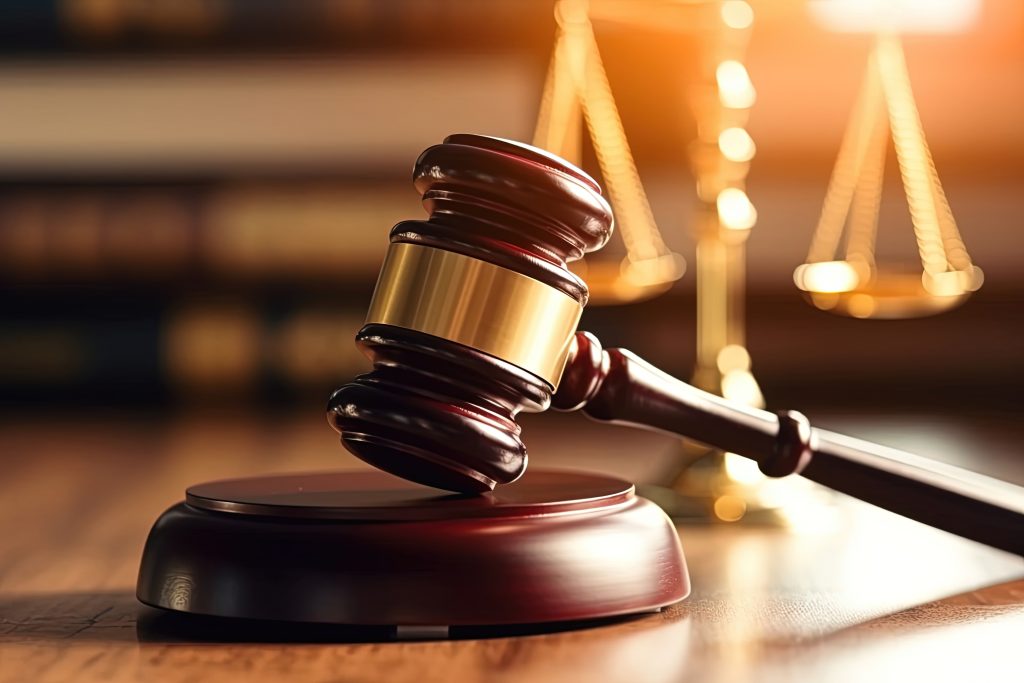 Concept of law and authority featuring a courtroom gavel, symbolizing the judgment of criminal acts, legislative authority, and judicial rulings