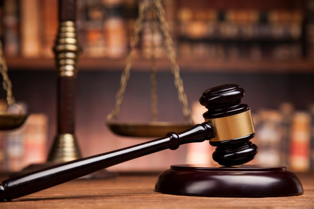 law theme, mallet of the judge, justice scale, books, wooden des