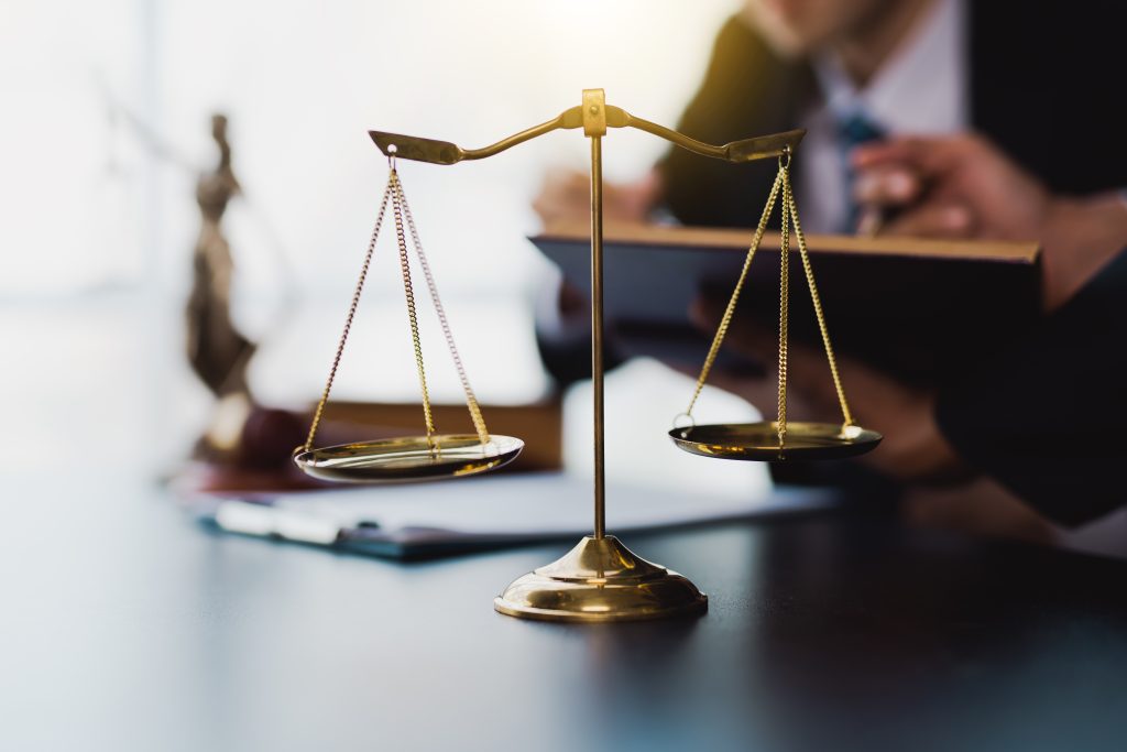 male lawyer discuss to a legal document explaining the terms of a consultation with a businessman. before signing a contract with a law firm.